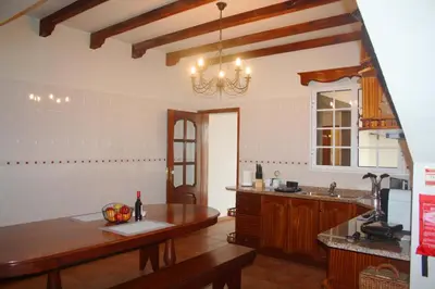 a kitchen with a table and a counter top at Lugar dos Louros 1 in Estreito da Calheta