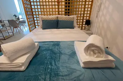 a large bed with two pillows on top of it at By the Sea III Lido - com piscina in Funchal