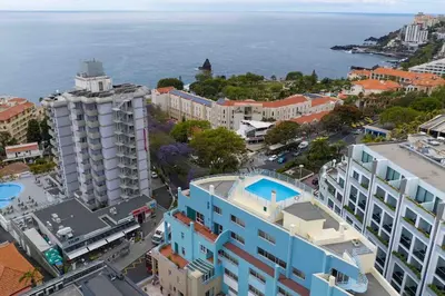 an aerial view of a city and the ocean at By the Sea III Lido - com piscina in Funchal