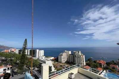 a view of a city with buildings and the ocean at By the Sea III Lido - com piscina in Funchal