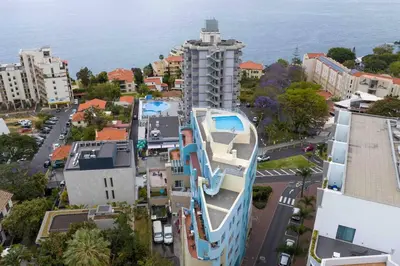 an aerial view of a building with a swimming pool at By the Sea III Lido - com piscina in Funchal