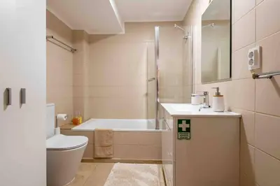 a bathroom with a tub and a toilet and a shower at By the Sea III Lido - com piscina in Funchal