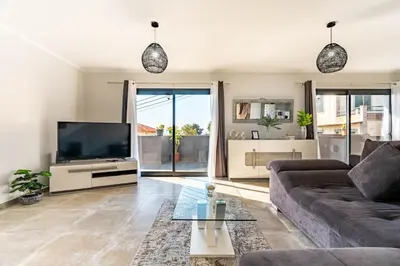 a kitchen with a washer and a couch in a room at Casa Yeni modern two bedrooms in Arco da Calheta