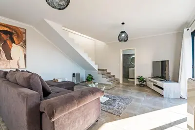 a kitchen with a vase of flowers on a counter at Casa Yeni modern two bedrooms in Arco da Calheta