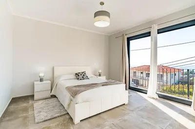 a white bed with a pillow on top of it at Casa Yeni modern two bedrooms in Arco da Calheta