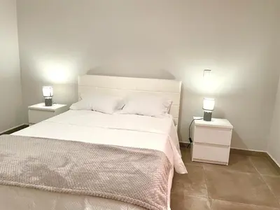 a bathroom with a toilet and a glass shower at Casa Yeni modern two bedrooms in Arco da Calheta