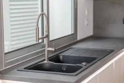 a kitchen sink with a faucet next to a window at Villa 65 - City Edge Retreat in Funchal