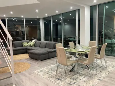 a living room with a table and a couch at Villa 65 - City Edge Retreat in Funchal