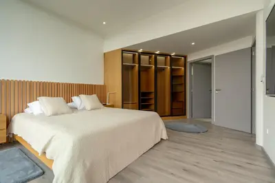 a bedroom with a large bed and a closet at Villa 65 - City Edge Retreat in Funchal