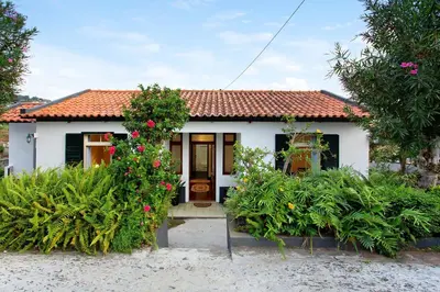 a small white house with a red roof at Casal Do Farrobo in Funchal