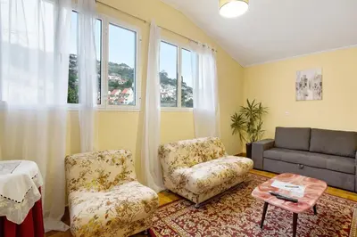 a living room with two chairs and a couch at Casal Do Farrobo in Funchal