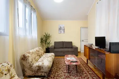 a living room with a couch and a television at Casal Do Farrobo in Funchal