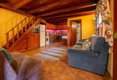 a living room with a couch and a kitchen at Villa Fontes 5 in Ponta Delgada