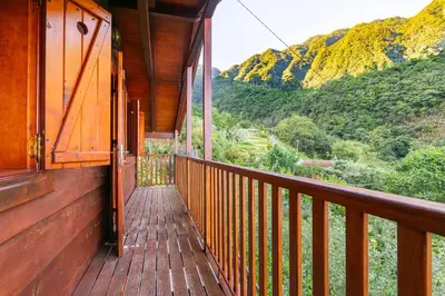 a wooden balcony with a view of a mountain at Villa Fontes 5 in Ponta Delgada