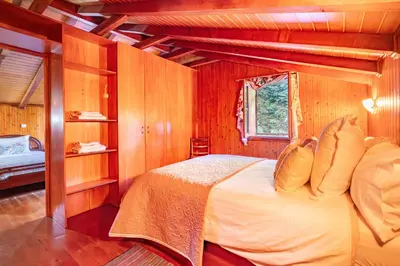 a bedroom with a bed in a wooden room at Villa Fontes 5 in Ponta Delgada