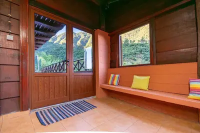 a room with a porch with a door and two windows at Villa Fontes 5 in Ponta Delgada