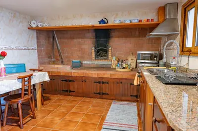 a kitchen with a counter and a stove top oven at Villa Fontes 7 in Ponta Delgada