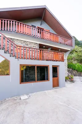 a house with a balcony on top of it at Villa Fontes 7 in Ponta Delgada