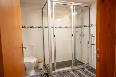 a bathroom with a shower and a toilet at Villa Fontes 7 in Ponta Delgada