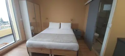 a bedroom with a white bed and a large window at Calheta Countryside in Calheta