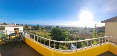 a balcony of a house with a yellow railing at Calheta Countryside in Calheta