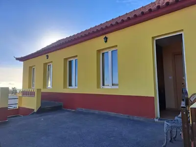 a yellow house with a lot of windows at Calheta Countryside in Calheta
