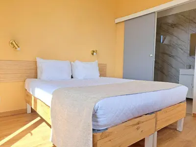 a bedroom with a large bed with white sheets at Calheta Countryside in Calheta
