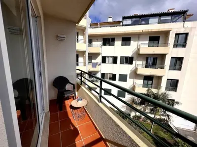 a balcony with a view of a building at By the Sea - Apartamento acolhedor e relaxante. in Caniço