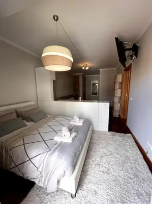 a bedroom with a bed with two towels on it at By the Sea - Apartamento acolhedor e relaxante. in Caniço