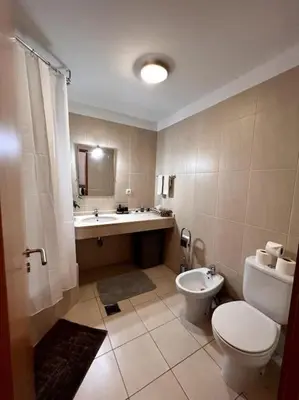 a bathroom with a toilet and a sink at By the Sea - Apartamento acolhedor e relaxante. in Caniço