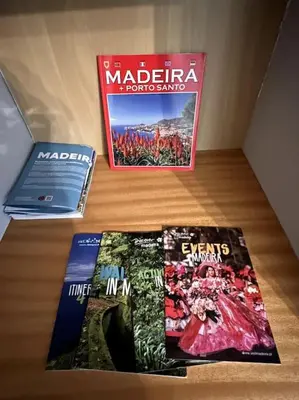 three books sitting on top of a table at By the Sea - Apartamento acolhedor e relaxante. in Caniço