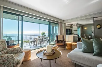 a living room with a couch and a dining room at Luxury Oceanfront at Reid's Gardens in Funchal