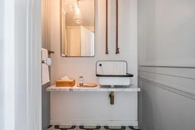 a small bathroom with a sink on a shelf at Luxury Oceanfront at Reid's Gardens in Funchal