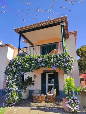 a house with a balcony with purple flowers at Quinta São Gonçalo in Funchal