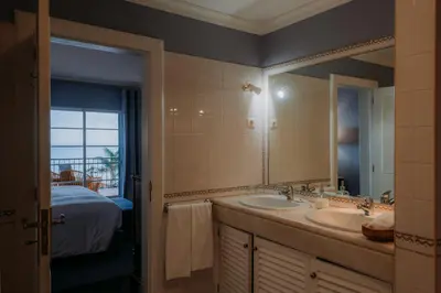 a bathroom with two sinks and a large mirror at Quinta São Gonçalo in Funchal
