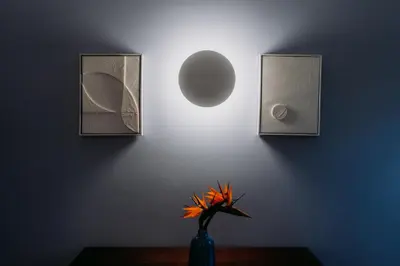 a vase with a flower on a table with a light at Quinta São Gonçalo in Funchal