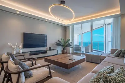 a living room with white furniture and a view of the ocean at The Stylish Apt. of Madeira Palace CC in Funchal