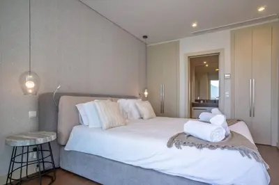 a bedroom with a large bed with a large window at The Stylish Apt. of Madeira Palace CC in Funchal
