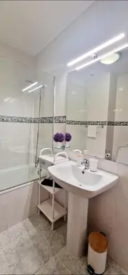 a white bathroom with a sink and a shower at Ocean Pearl Apartment Y in Funchal