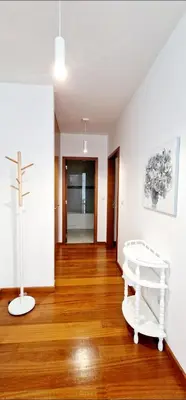 a room with a cross and a white bench on a wooden floor at Ocean Pearl Apartment Y in Funchal