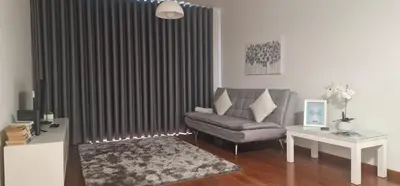 a living room with a chair and a window with curtains at Ocean Pearl Apartment Y in Funchal