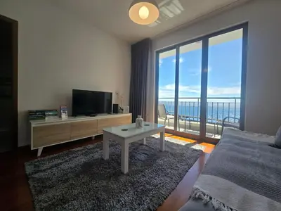 a living room with a tv and a large window at Ocean Pearl Apartment Y in Funchal