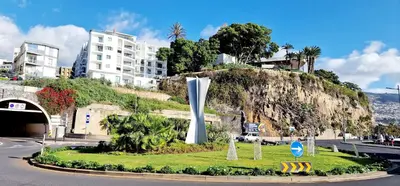 a street with a monument in the middle of a city at Ocean Pearl Apartment Y in Funchal