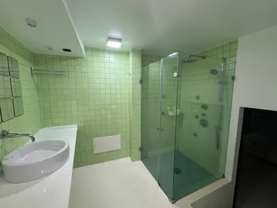 a bathroom with a glass shower and a sink at Sea Breeze Boutique House in Porto da Cruz