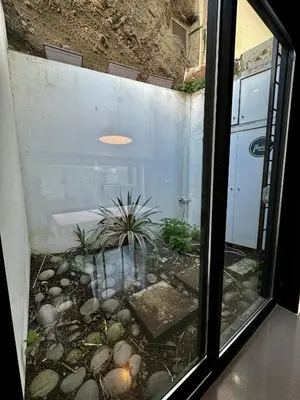 a window view of a patio with a plant at Sea Breeze Boutique House in Porto da Cruz