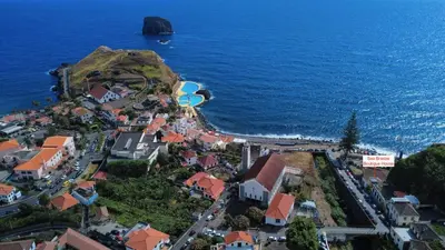 an aerial view of a town on a hill next to the ocean at Sea Breeze Boutique House in Porto da Cruz