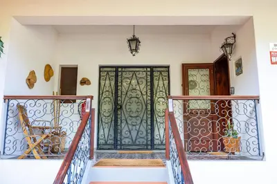 a front door of a house with a gate at Vila Gama Apartaments in Machico