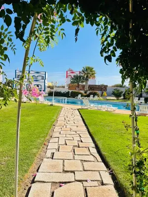 a stone pathway leading to a swimming pool at Bella Sunset Holidays - 3 min da Praia da Mareta in Sagres
