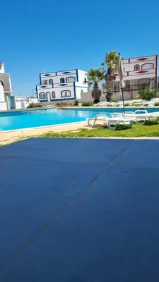 a swimming pool in front of a building with a house at Bella Sunset Holidays - 3 min da Praia da Mareta in Sagres