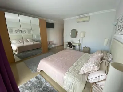 a bedroom with a large bed and a large mirror at Beautiful 2 bed townhouse on Boavista golf course in Lagos
